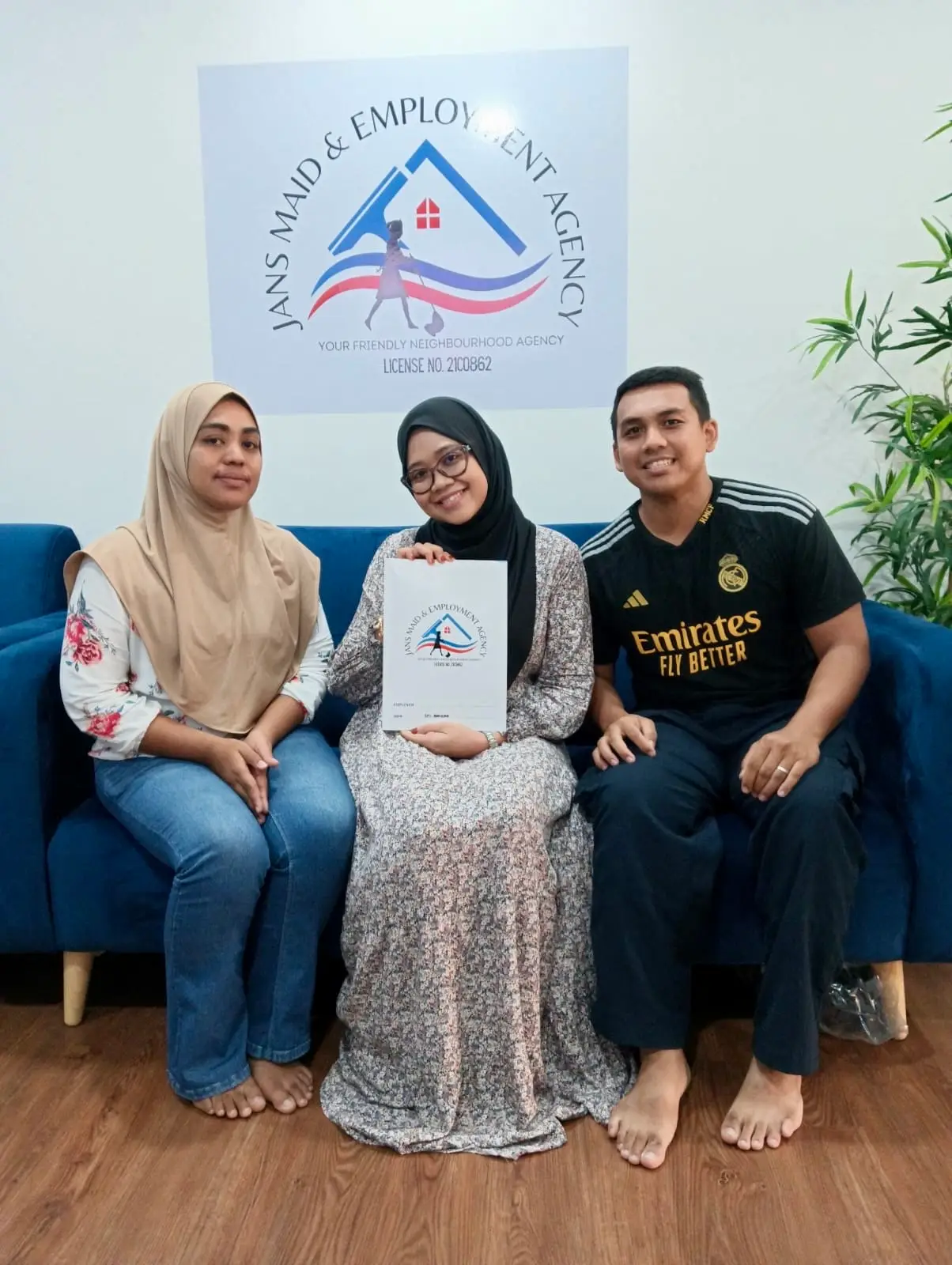 Satisfied maid agency Singapore clients with Jans Maid holding agreement