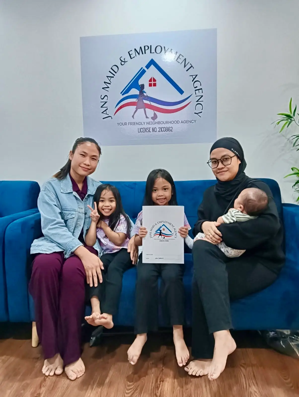 Happy maid agency Singapore clients smiling in office
