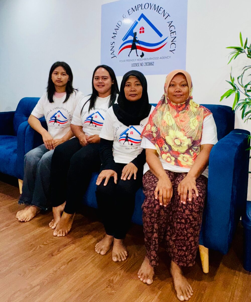 Indonesian domestic helper with Singapore employer family at Jans Maid office